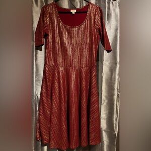 Dark red Amelia dress with gold accents throughout. From the holiday collection.